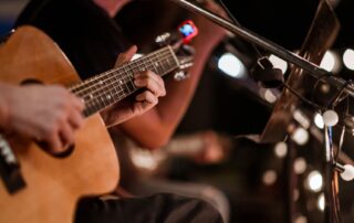 Close Up Of Guitar In Hand