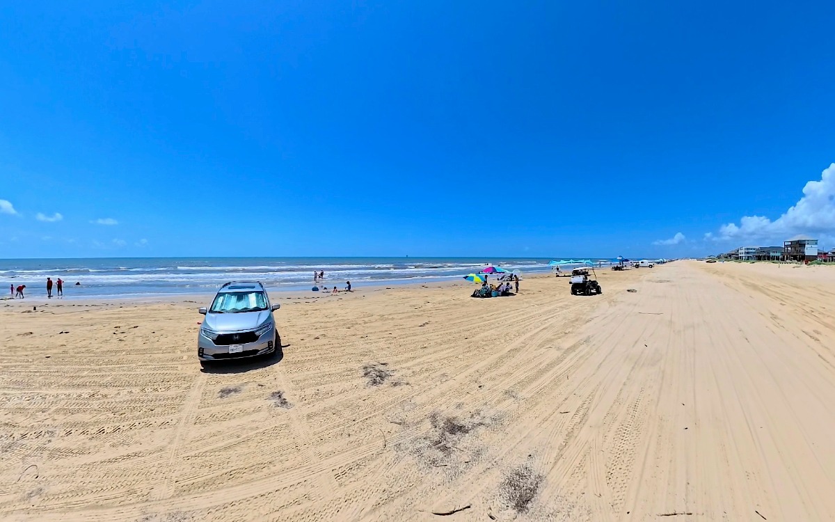 View of beachfront, families, and waves.