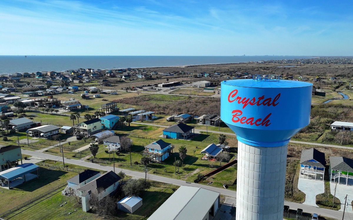 new crystal beach texas water tower with surf in background